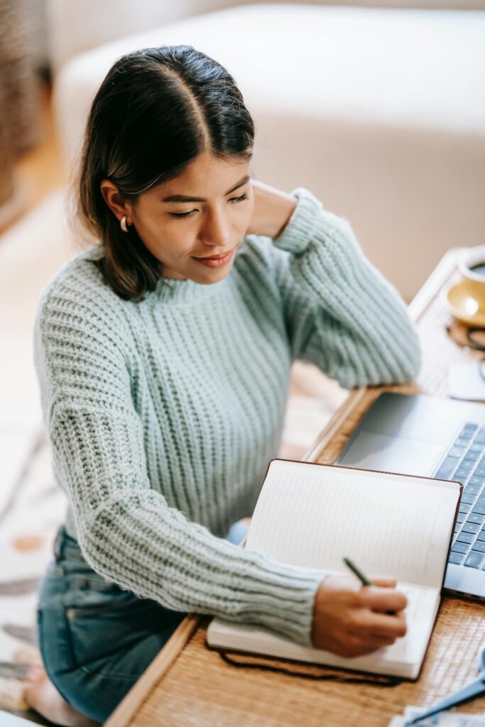 woman writing on an undated planner