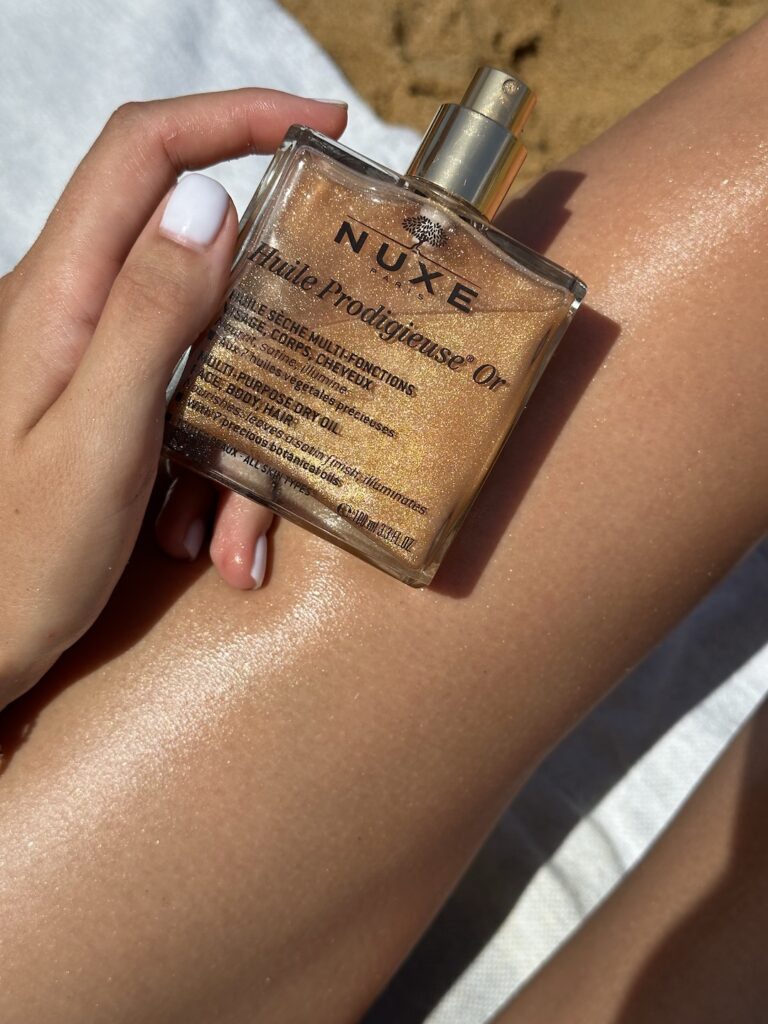 Get Glowing and Smooth Skin All Over With the Help of These Body Oils 3 lady holding a body oil in her left hand with her leg as a background