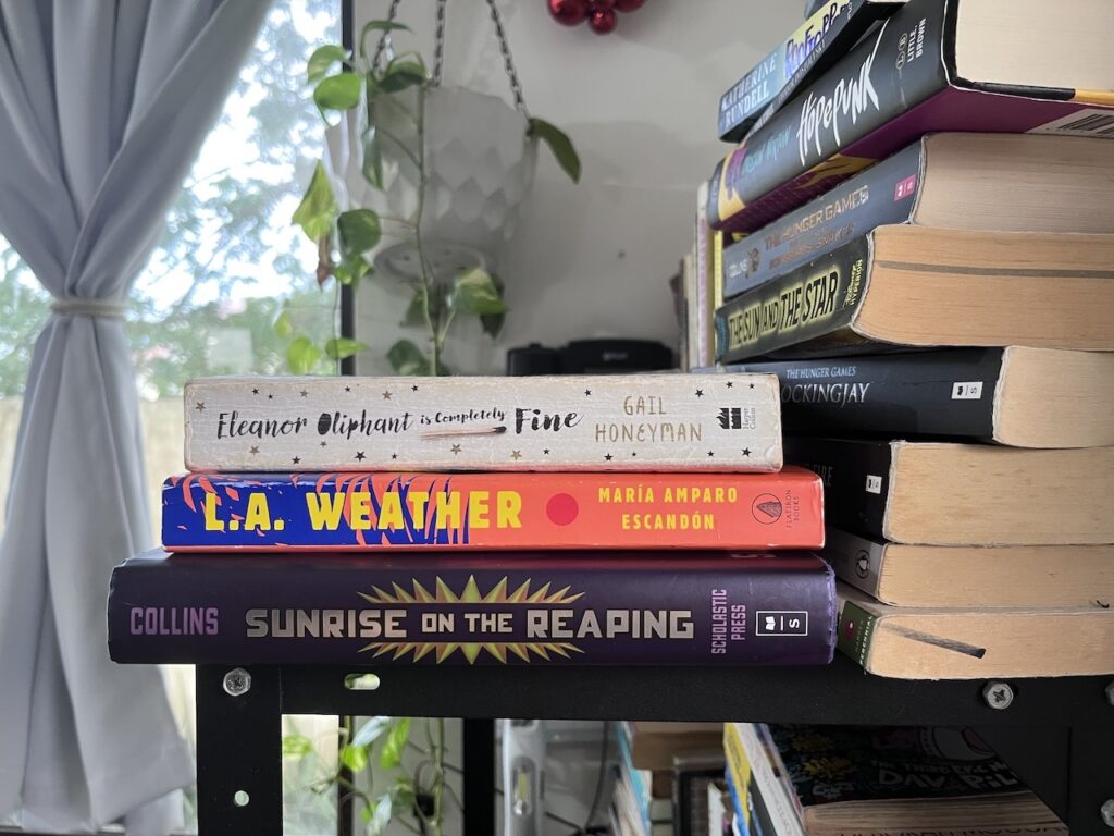 The Keyword Is Try 3 a stack of the books i read in september, from top to bottom: eleanor oliphant is completely fine by gail honeyman, l.a. weather by maria amparo escandon, and sunrise on the reaping by suzanne collins.